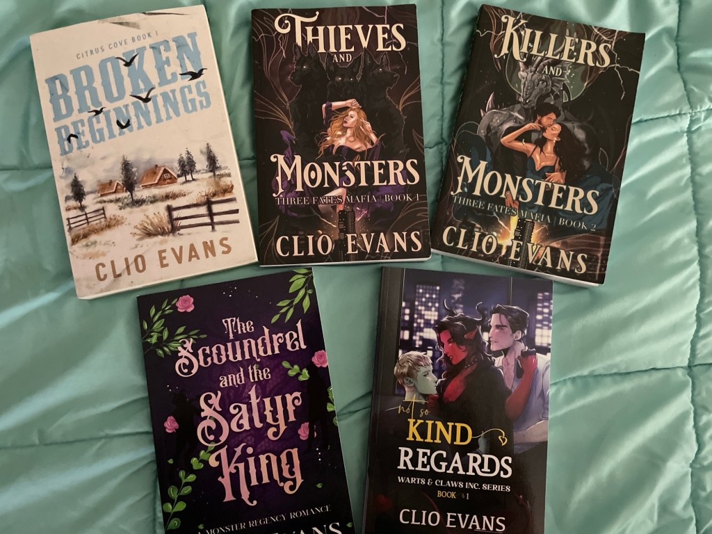 photo showing various titles by Clio Evans. books from top row, left to right: Broken Beginnings, Thieves and Monsters, Killers and Monsters. Books from bottom row, left to right: The Scoundrel and the Satyr King and Not so Kind Regards
